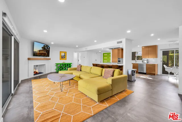 a living room with furniture window and a flat screen tv