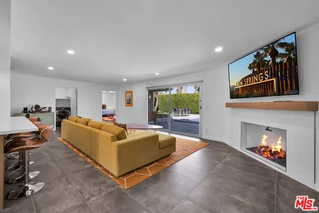a large kitchen with stainless steel appliances kitchen island granite countertop a sink and cabinets