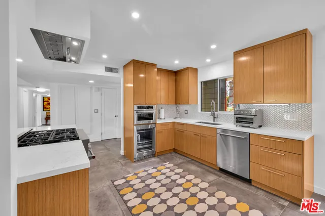 a kitchen with a sink cabinets and refrigerator