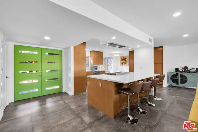 a large kitchen with lots of counter space and windows