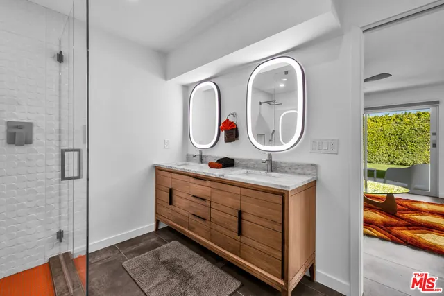 a bedroom with a bed and a large window with balcony view