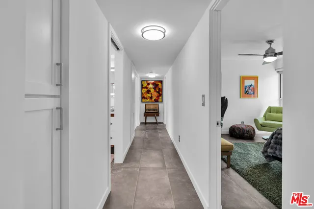 a bathroom with a granite countertop sink mirror vanity and bathtub