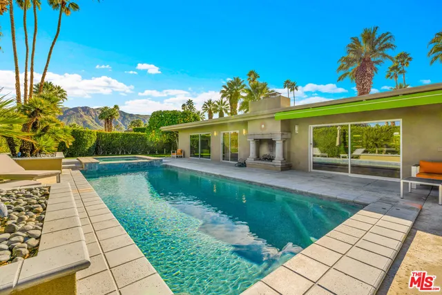 a view of a swimming pool with an outdoor seating