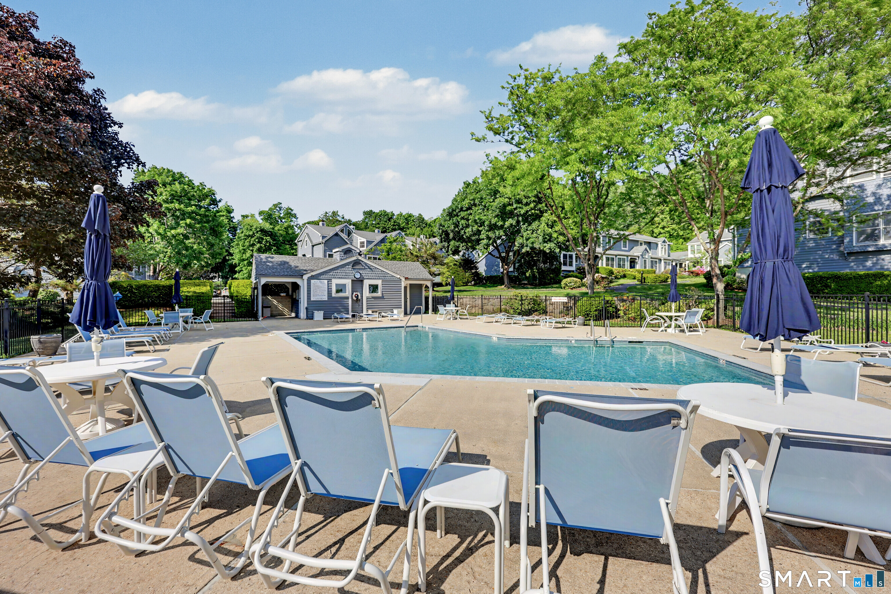 70 Fawn Ridge Lane, Unit 70 Norwalk, CT 06851 - Photo 33 of 36 a view of a chairs and table in patio with a lake view