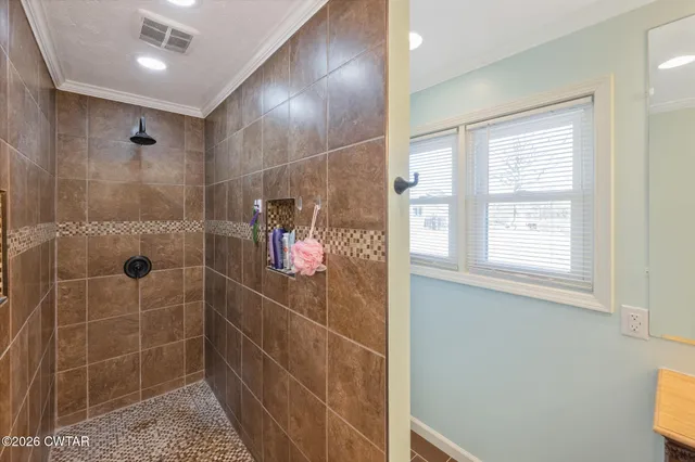 a bathroom with a double vanity sink mirror and shower