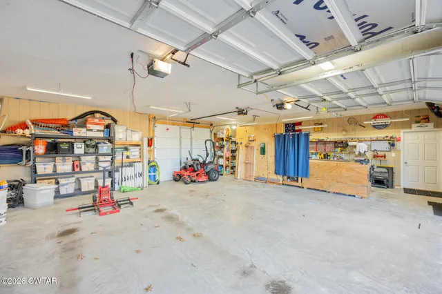 a view of swimming pool with lounge chair and dinning table under an umbrella