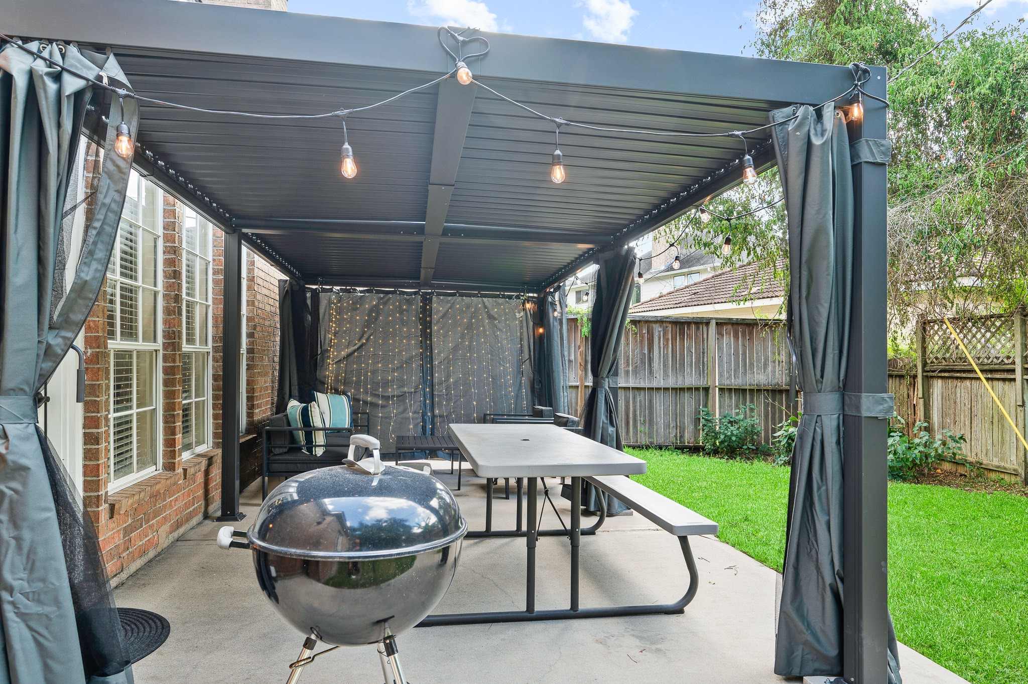8111 Morningbrook Court Spring, TX 77379 - Photo 42 of 46 The expansive covered patio flows seamlessly into the backyard, providing a perfect setting for entertaining or spending quiet moments outdoors. Overlooking the large yard, the patio offers a serene space for play, gardening, or simply enjoying the peaceful surroundings.