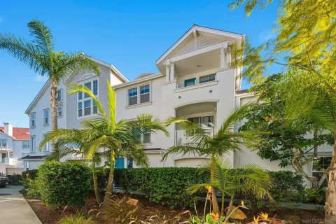 a view of a multi story residential apartment building with a yard