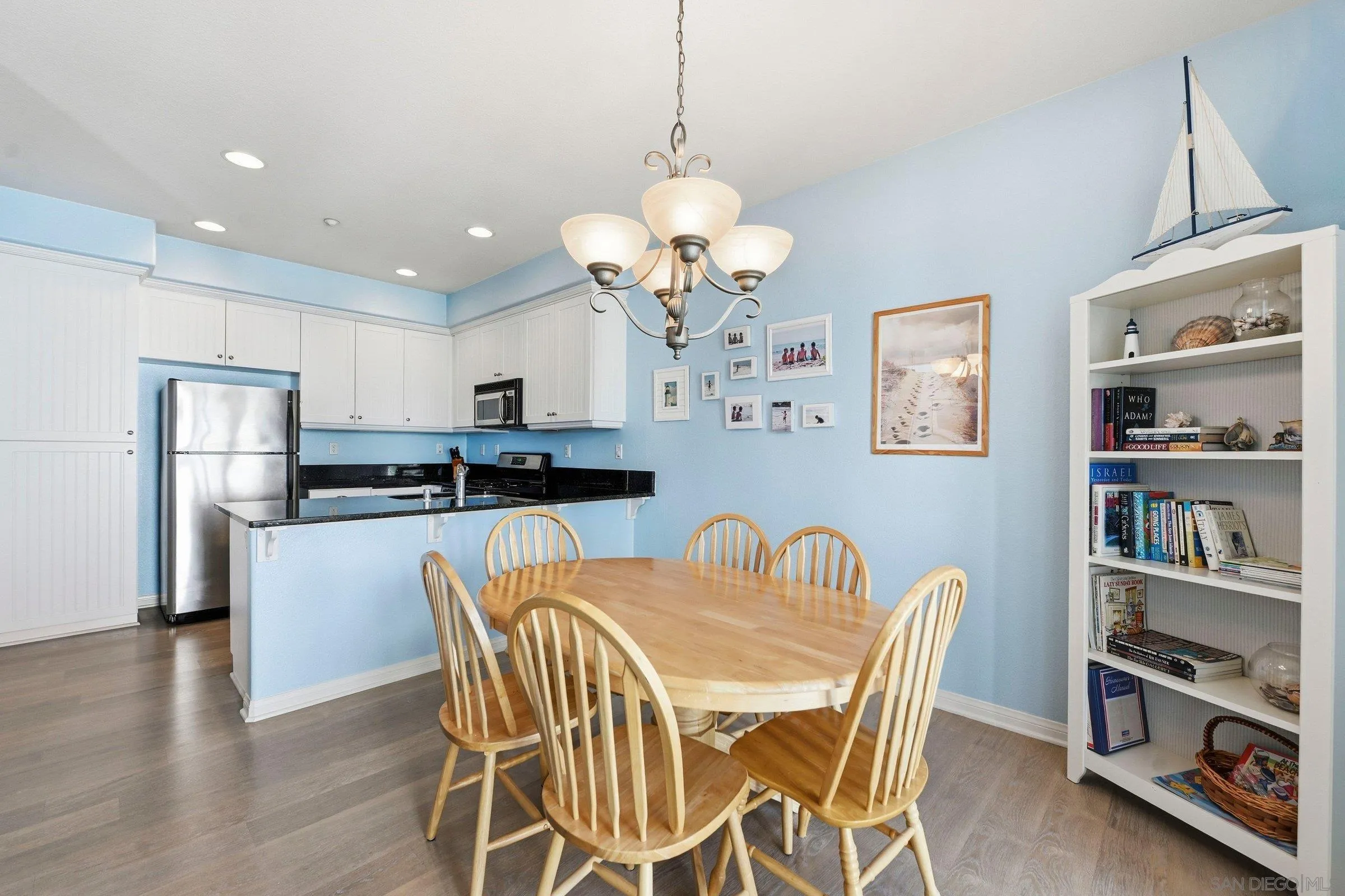 845 Harbor Cliff Way, Unit 305 Oceanside, CA 92054 - Photo 11 of 31 a view of a dining room with furniture and wooden floor