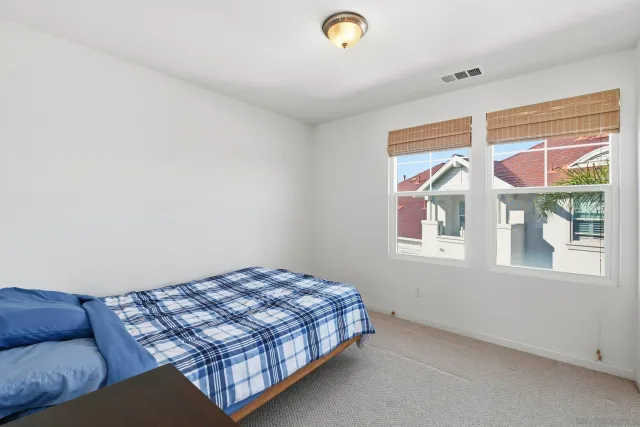 a bedroom with a bed and window