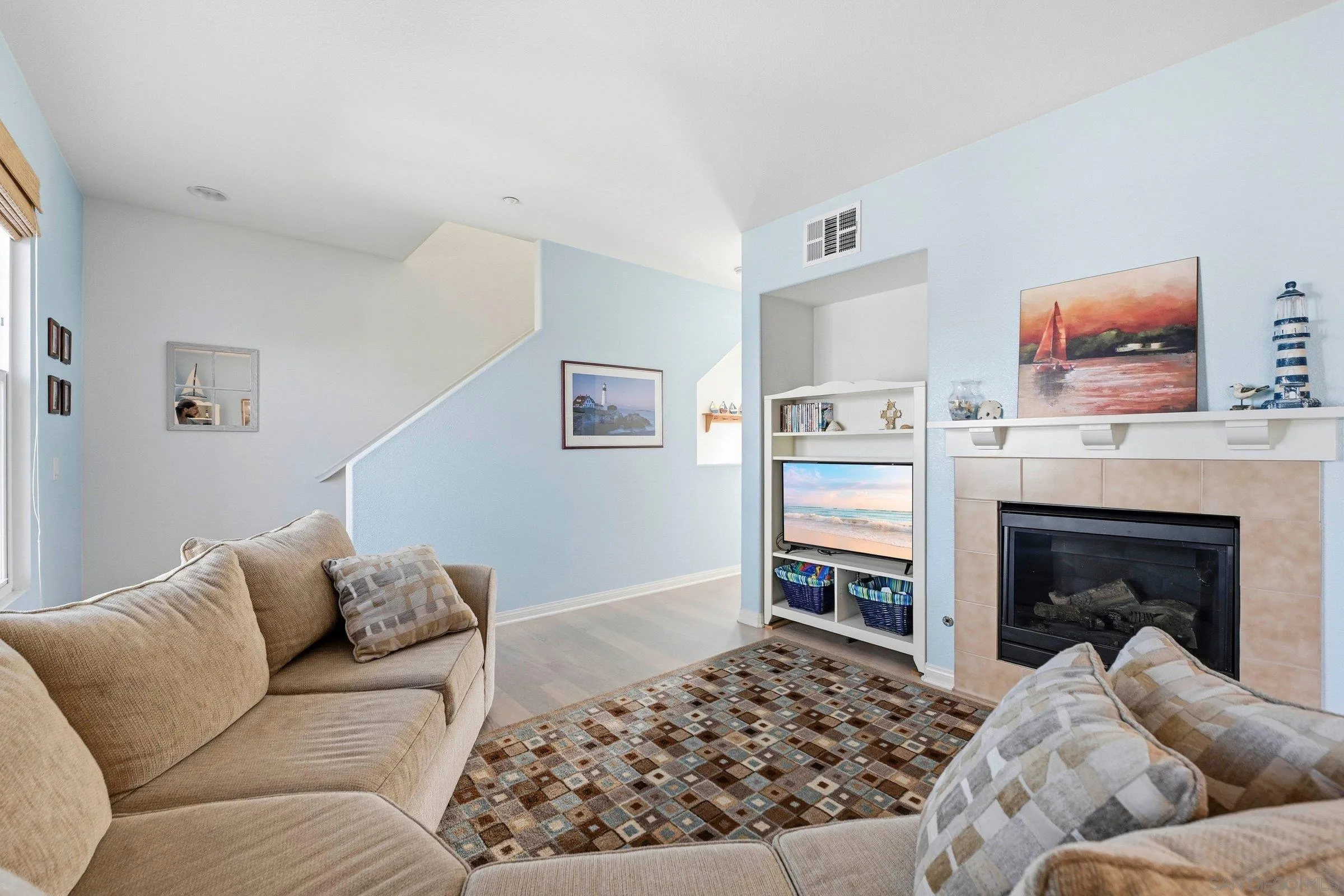 845 Harbor Cliff Way, Unit 305 Oceanside, CA 92054 - Photo 10 of 31 a living room with furniture and a fireplace