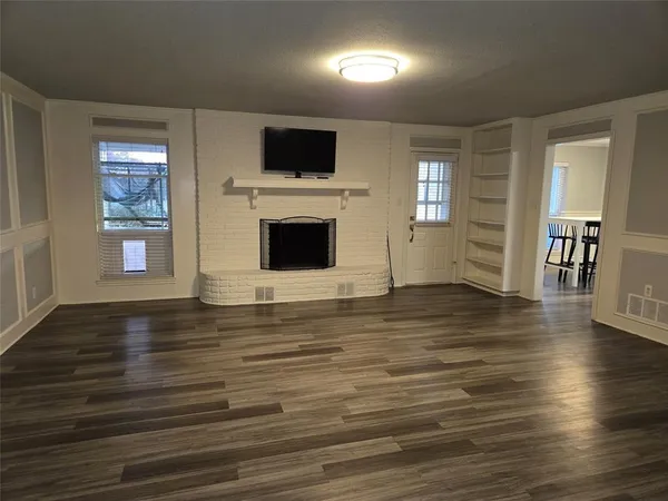 a view of a livingroom with an empty space and a window