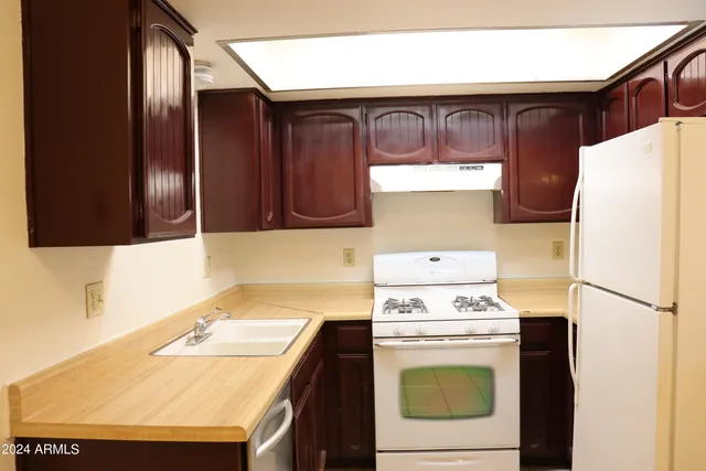 a kitchen with a stove and a refrigerator