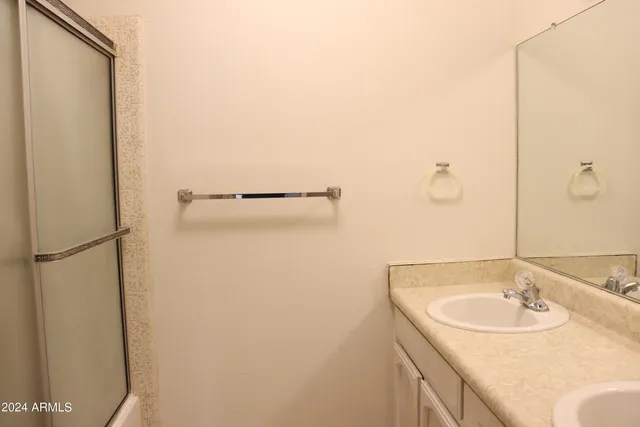 a bathroom with a sink and mirror