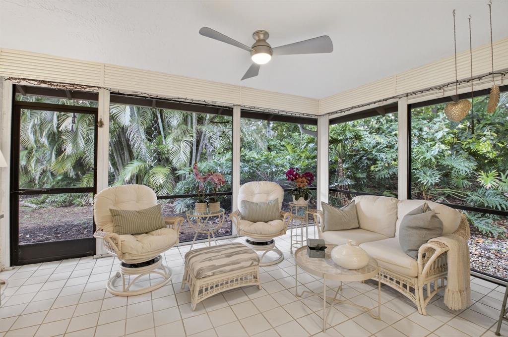 19452 Waters Reach Lane, Unit 305 Boca Raton, FL 33434 - Photo 29 of 77 a living room with patio furniture and a large window