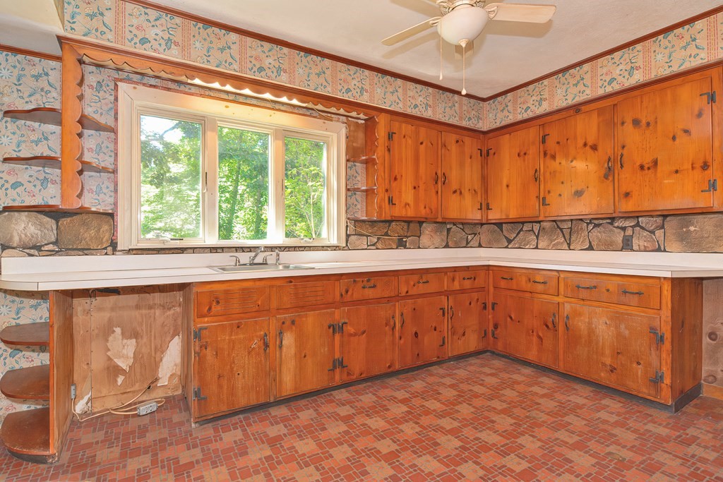 76 Brook Street Holliston, MA 01746 - Photo 23 of 31 a kitchen with stainless steel appliances sink cabinets and window