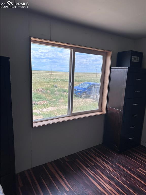 30595 Fred View Road Yoder, CO 80864 - Photo 21 of 21 a view of an empty room with wooden floor and a window