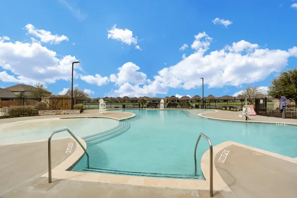 a view of a swimming pool and a patio