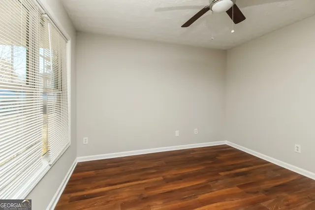 wooden floor in an empty room with a window