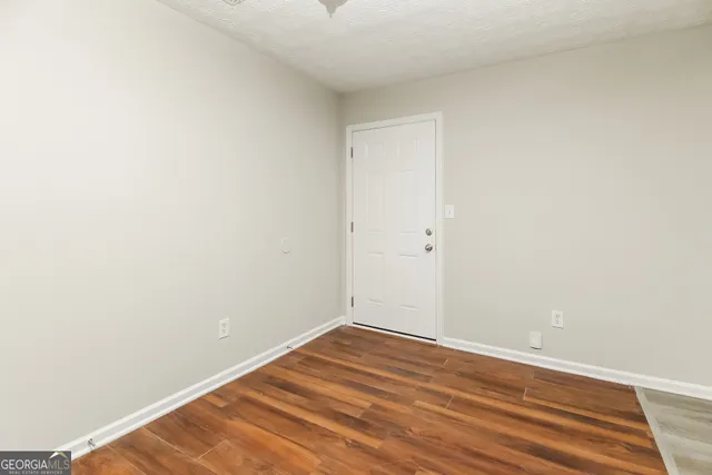 a view of a room with wooden floor