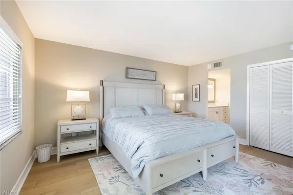 a bedroom with a bed and a lamp