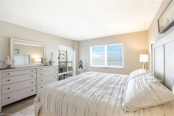 a bedroom with a large bed and a dresser