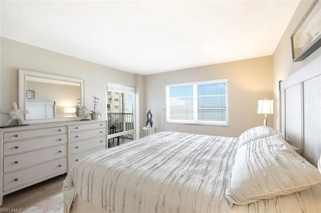 a bedroom with a large bed and a dresser