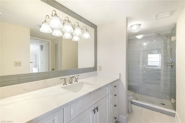 a bathroom with a sink a large mirror and a shower