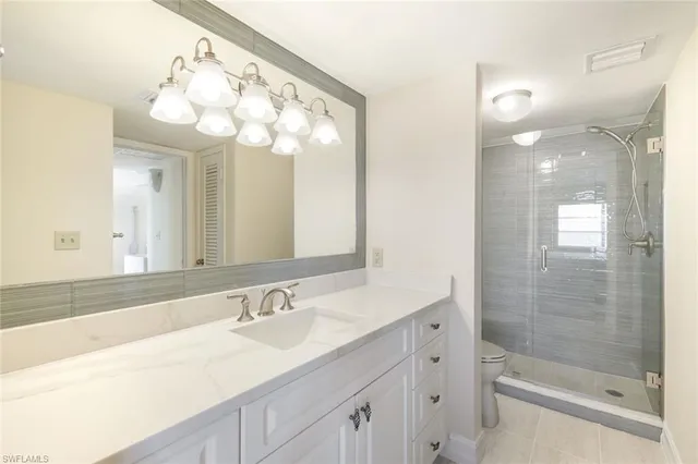 a bathroom with a sink a large mirror and a shower