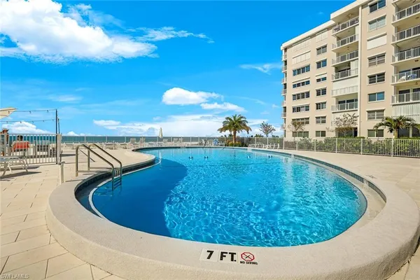 a view of a swimming pool with an outdoor seating