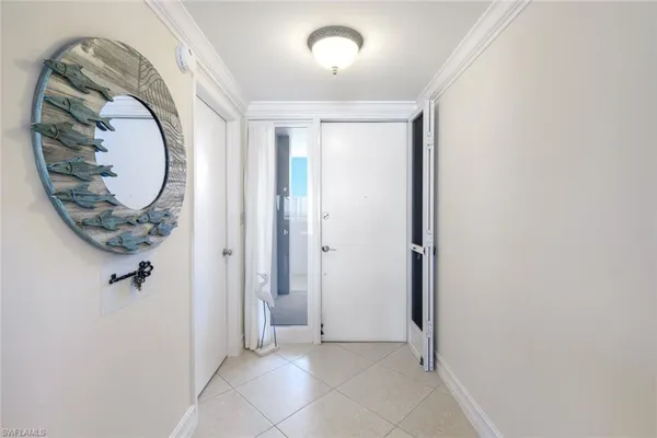 a view of a hallway with wooden floor and a mirror