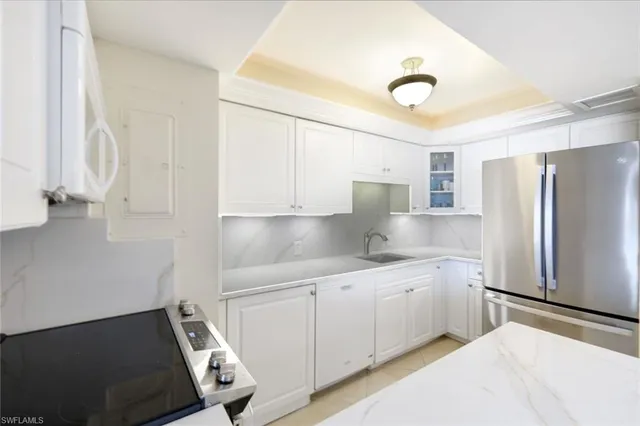 a kitchen with a sink appliances and cabinets