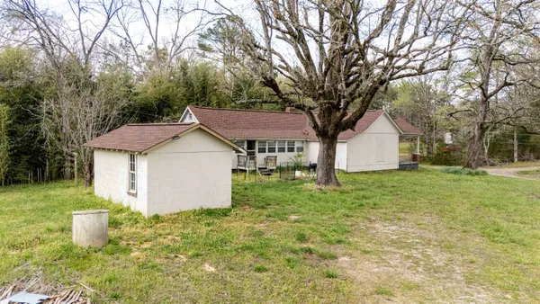 a view of a house with yard and tree s