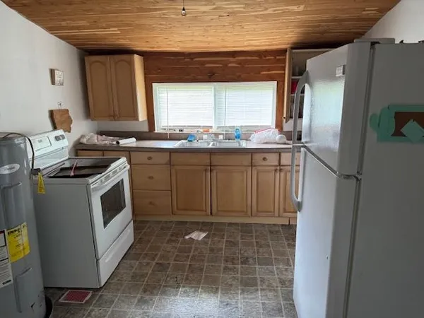 a kitchen with a stove a sink and a refrigerator