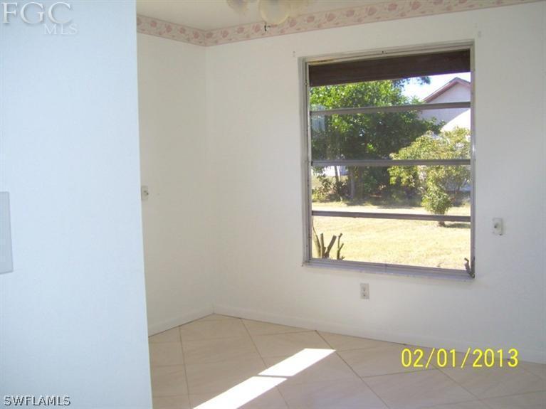 113 Georgia Road Lehigh Acres, FL 33936 - Photo 5 of 9 a view of an empty room with a window