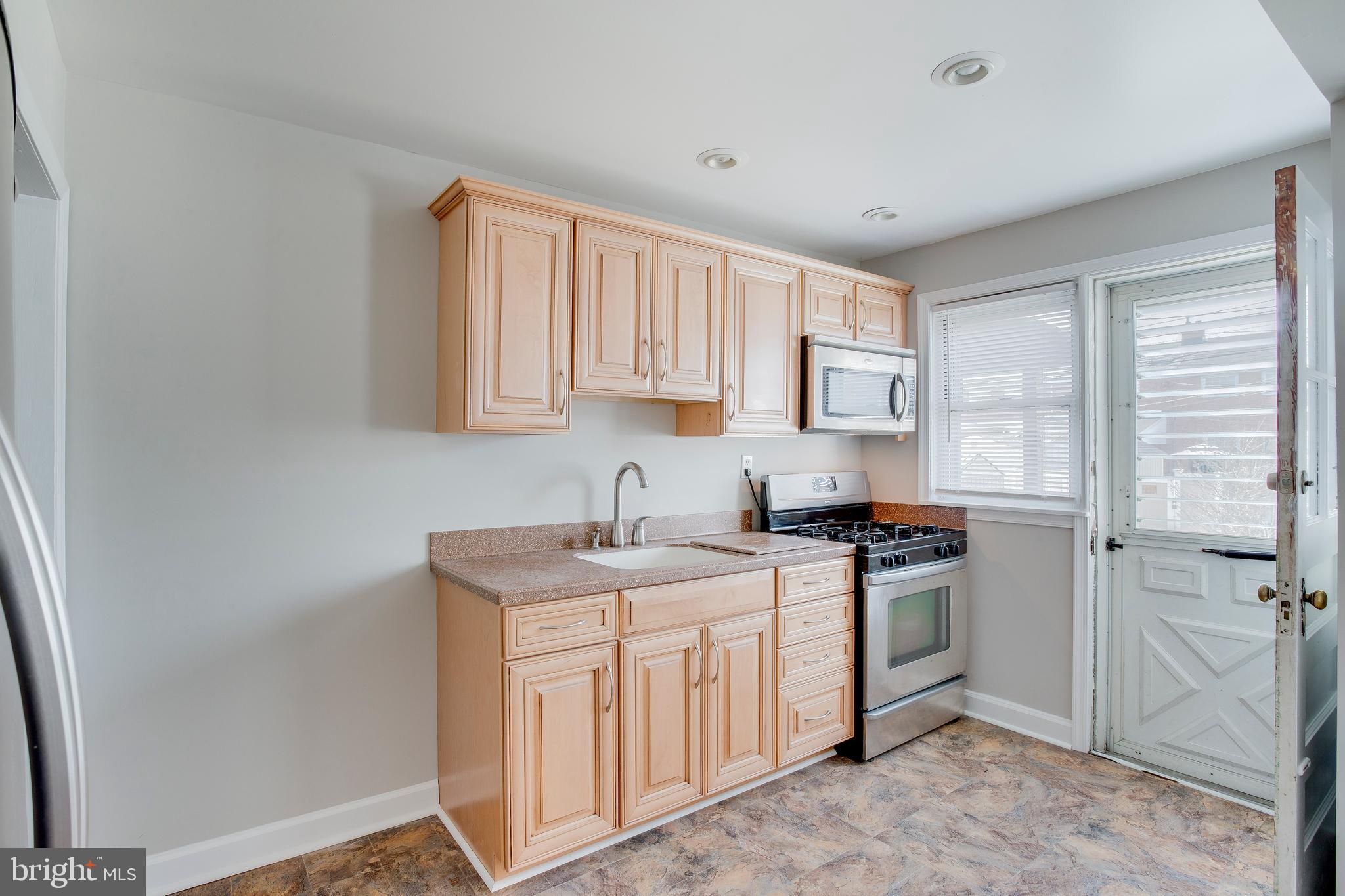 2255 Searles Road Baltimore, MD 21222 - Photo 5 of 13 a kitchen with a sink stove and refrigerator