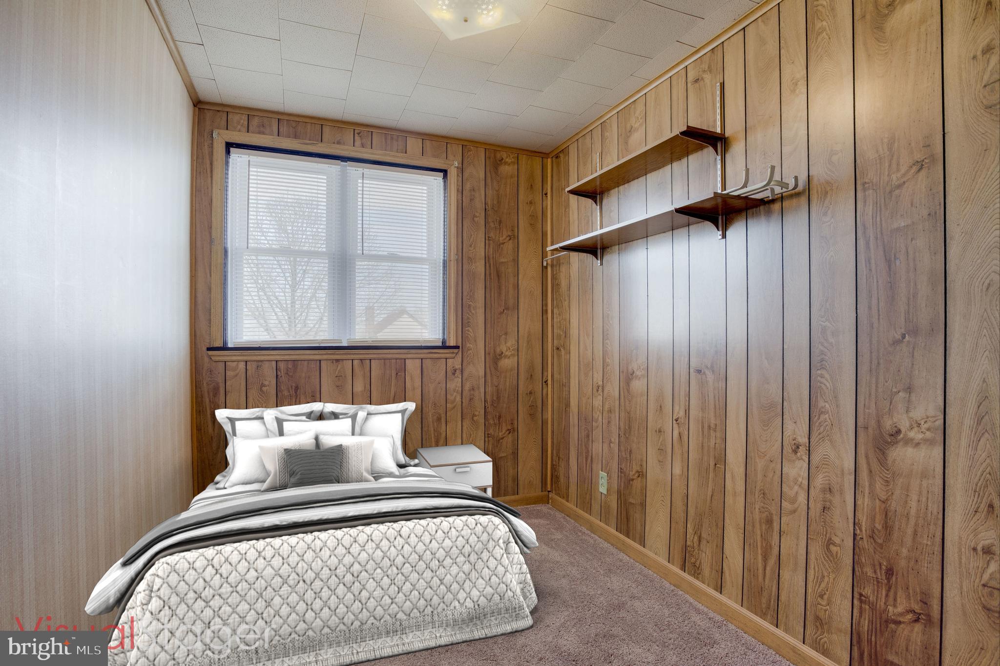 2255 Searles Road Baltimore, MD 21222 - Photo 9 of 13 a view of a bedroom with a bed and wooden floor