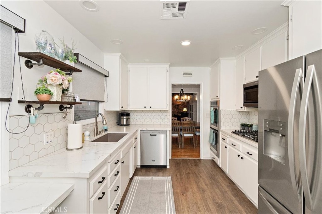8530 Harmony Lane Riverside, CA 92504 - Photo 11 of 40 a kitchen with a sink appliances and cabinets