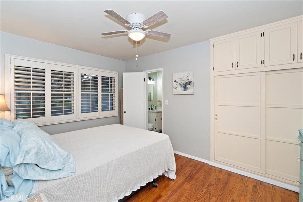 8530 Harmony Lane Riverside, CA 92504 - Photo 20 of 40 a spacious bedroom with a large bed and a chandelier