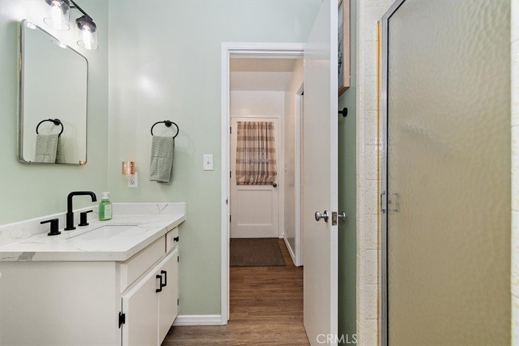 8530 Harmony Lane Riverside, CA 92504 - Photo 21 of 40 a bathroom with a sink a mirror and shower