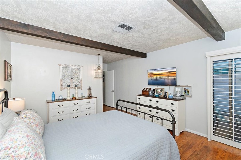 8530 Harmony Lane Riverside, CA 92504 - Photo 29 of 40 a bedroom with furniture and a wooden floor