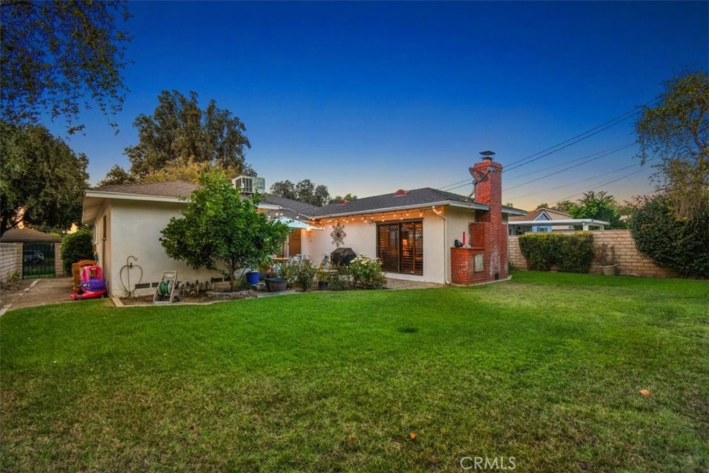 8530 Harmony Lane Riverside, CA 92504 - Photo 32 of 40 a front view of a house with a yard and garage