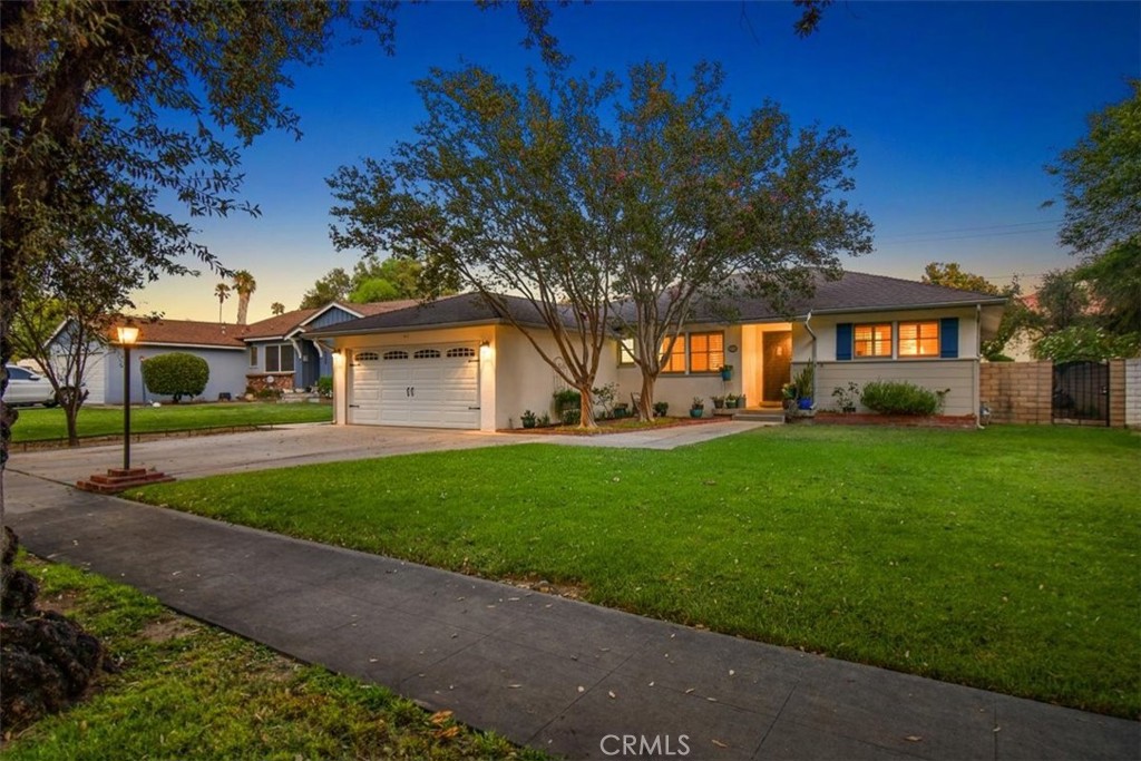 8530 Harmony Lane Riverside, CA 92504 - Photo 35 of 40 a front view of a house with a garden and trees