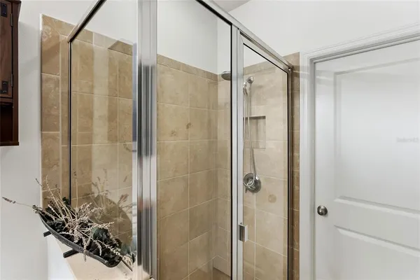 a bathroom with a shower and a sink