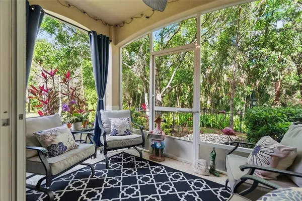 a living room with patio furniture and a potted plants