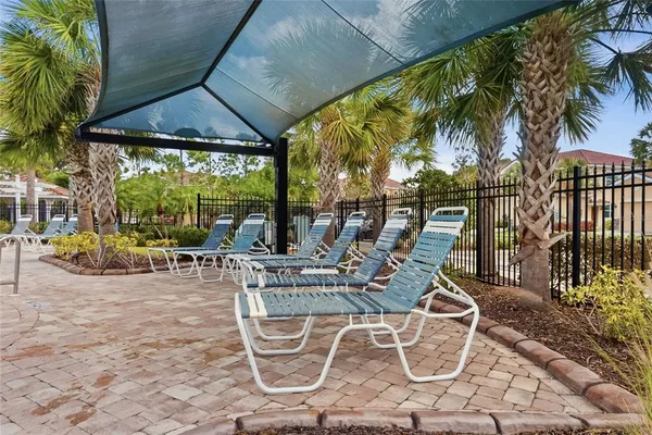a view of a swimming pool with chairs and table