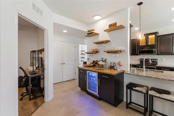 a kitchen with granite countertop a sink appliances and cabinets