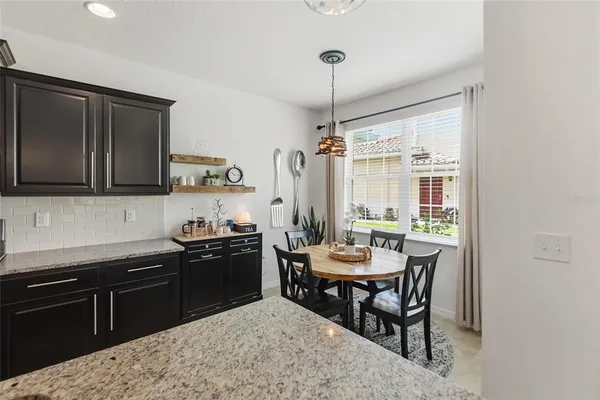 a kitchen with a table chairs stove and refrigerator