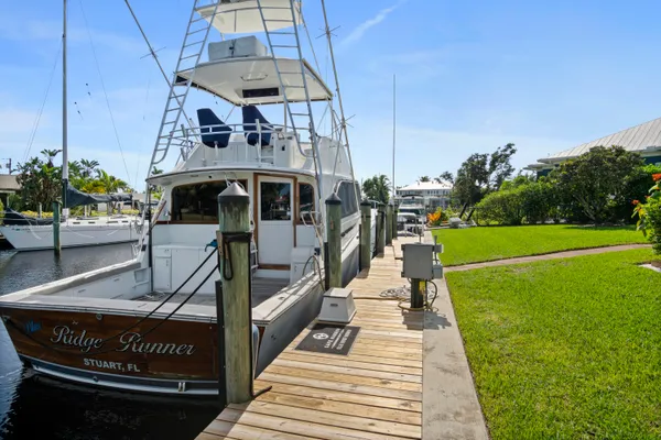 a swimming pool with outdoor seating and barbeque oven