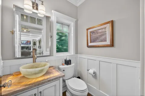 a bathroom with a toilet a sink and a window